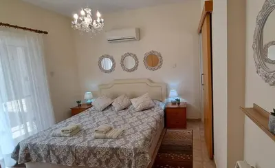 a bedroom with a bed with two towels on it at VILLA MARINA BY FIG TREE BAY in Protaras