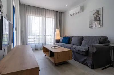 a living room with a couch and a coffee table at A Blissful 1-Bedroom Voyage in Larnaca in Larnaka