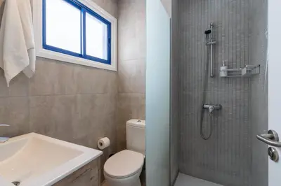a bathroom with a toilet and a sink and a shower at A Blissful 1-Bedroom Voyage in Larnaca in Larnaka