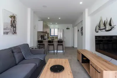 a living room with a couch and a table at A Blissful 1-Bedroom Voyage in Larnaca in Larnaka