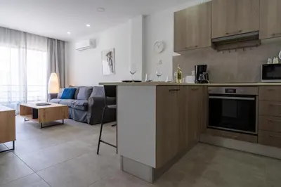a kitchen and living room with a couch at A Blissful 1-Bedroom Voyage in Larnaca in Larnaka