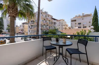 a balcony with two chairs and a table on a balcony at A Blissful 1-Bedroom Voyage in Larnaca in Larnaka