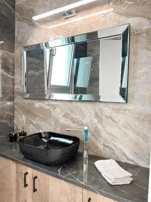 a bathroom with a black sink and a mirror at City Lights - Luxury Penthouse - Panoramic view - Near Unic in Nicosia