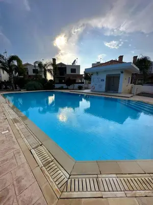 a large blue swimming pool in front of a house at Sotira Agia Napa Luxury House in Ayia Napa