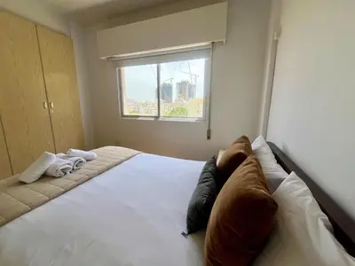 a bedroom with a bed with two pillows and a window at 1BDR Affortable and Cozy Stay in Nicosia - Ioanni Polemi By Platform 357 in Nicosia