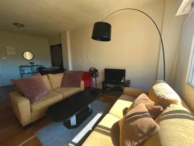 a living room with a couch and a lamp at 1BDR Affortable and Cozy Stay in Nicosia - Ioanni Polemi By Platform 357 in Nicosia