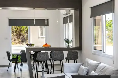 a kitchen and living room with a table and chairs at Napa Bay View Villa 8 in Ayia Napa