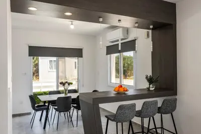 a kitchen and dining room with a table and chairs at Napa Bay View Villa 8 in Ayia Napa