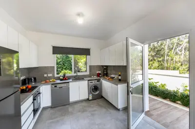 a kitchen with white cabinets and stainless steel appliances at Napa Bay View Villa 8 in Ayia Napa