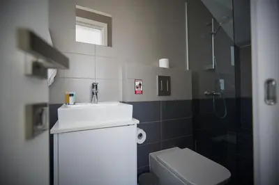 a bathroom with a sink and a toilet at Protaras Olivine Villa Ol01 in Paralimni