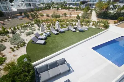 an aerial view of a resort with chairs and a pool at Protaras Olivine Villa Ol01 in Paralimni