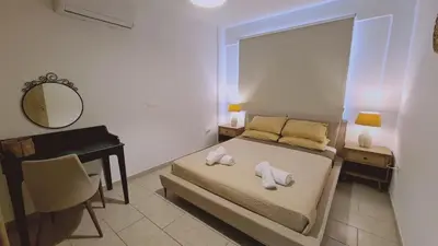 a bedroom with a bed and a desk and a mirror at STAY Mermaid's Cove in Limassol