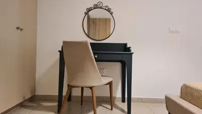 a chair sitting in front of a desk with a mirror at STAY Mermaid's Cove in Limassol