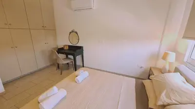 a bedroom with a bed and a desk with a mirror at STAY Mermaid's Cove in Limassol