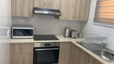a kitchen with a microwave oven and a sink at Prestige Worldwide Apartments in Ayia Napa