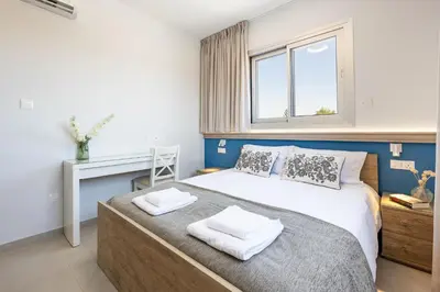 a bedroom with a bed and a window at Rodoni Residence in Strovolos