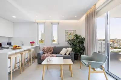 a living room and kitchen with a couch and a table at Rodoni Residence in Strovolos