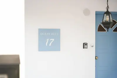 a sign on the door of an open clinic at Ocean Blue House 17 in Meneou