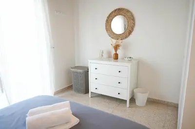 a bedroom with a bed and a mirror and a dresser at Ocean Blue House 17 in Meneou