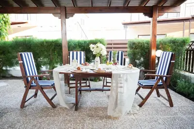 a wooden table with chairs and a table cloth at Ocean Blue House 17 in Meneou