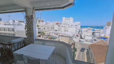 a balcony with a table and a view of a city at STAY Kallucci's maison de la mer in Larnaka