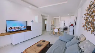 a living room with a couch and a flat screen tv at STAY Kallucci's maison de la mer in Larnaka