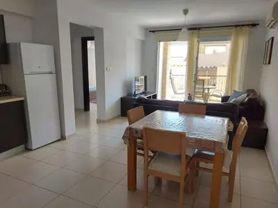 a kitchen and living room with a table and chairs at Pyla Palms A2 107 in Pyla