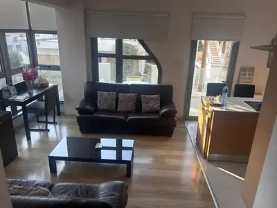 a living room with a couch and a table at Alex Residence in Larnaka