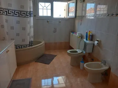 a bathroom with a tub and a toilet and a sink at Vasilis House family room in Larnaka