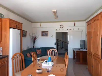 a living room with a table and a couch at Vasilis House family room in Larnaka