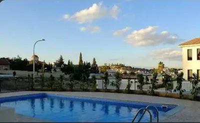 a large swimming pool in front of a building at Tersefanou Traditional Village Larnaca in Larnaka