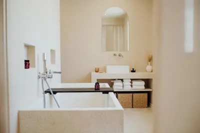 a bathroom with a large tub and a sink at Thymises Boutique Hotel in Kakopetria