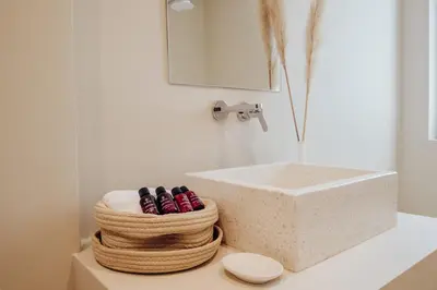 a bathroom with a sink and a pile of towels at Thymises Boutique Hotel in Kakopetria