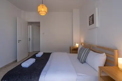 a bedroom with a large white bed with two pillows at Blossom 1-Bedroom Apartment in Larnaca in Larnaka
