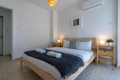 a bedroom with a bed with two towels on it at Blossom 1-Bedroom Apartment in Larnaca in Larnaka