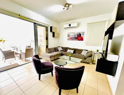 a living room with a couch and chairs at LARA 303 in Larnaka