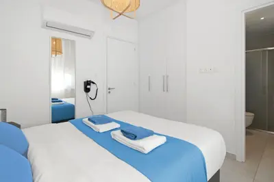a white bedroom with a bed with towels on it at Villa Amazonia - Large Private Pool in Protaras