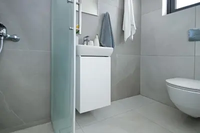 a bathroom with a white sink and a toilet at Villa Amazonia - Large Private Pool in Protaras