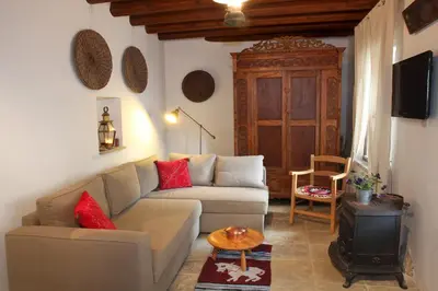 a living room with a couch and a wood stove at Kalopanayiotis Cottage in Kalopanayiotis