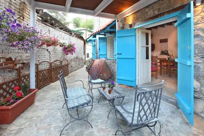 a patio in a house with chairs and a table at Kalopanayiotis Cottage in Kalopanayiotis