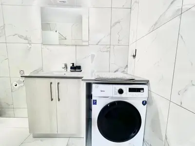 a washing machine in a bathroom with a sink at Stay With Oleg C111 in Paralimni