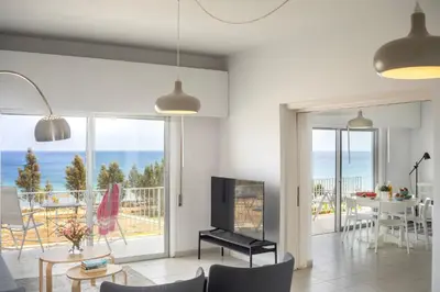 a living room with a view of the ocean at Protaras H2O Seafront Suite in Protaras