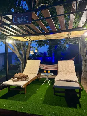 two chairs and a table in a gazebo with a hammock at Villa Christina in Protaras