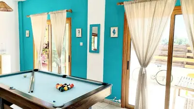 a pool table in a room with blue walls at Villa Christina in Protaras