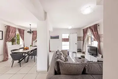 a living room with a couch and a table at Nissini villa in Ayia Napa