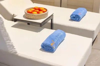 two beds with towels and a bowl of tomatoes on them at Nissini villa in Ayia Napa