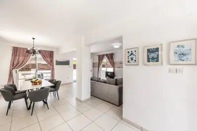 a living room and dining room with a table and chairs at Nissini villa in Ayia Napa
