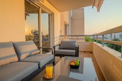 a living room with a couch and a table on a balcony at Perfect for families, Beach 3 Min away, Brand New in Limassol