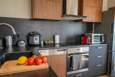 a kitchen with a cutting board with tomatoes on it at Perfect for families, Beach 3 Min away, Brand New in Limassol