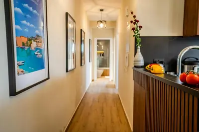 a hallway leading to a kitchen with paintings on the walls at Perfect for families, Beach 3 Min away, Brand New in Limassol